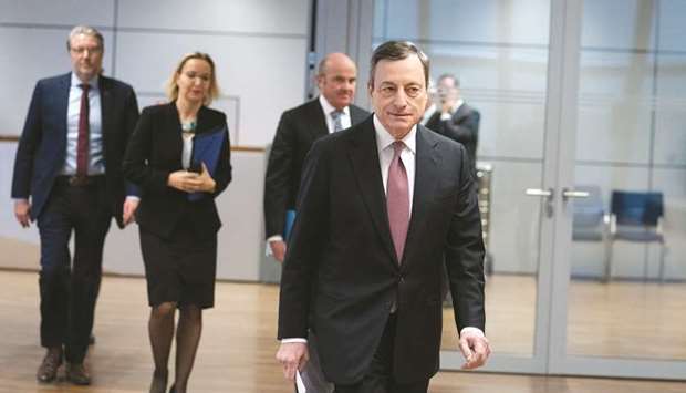 ECB president Mario Draghi arrives for the rates decision news conference in Frankfurt yesterday. u201cThe risks surrounding the euro area growth outlook have moved to the downside on account of the persistence of uncertainties,u201d Draghi told a news conference, citing trade and geopolitical threats and emerging market volatility.