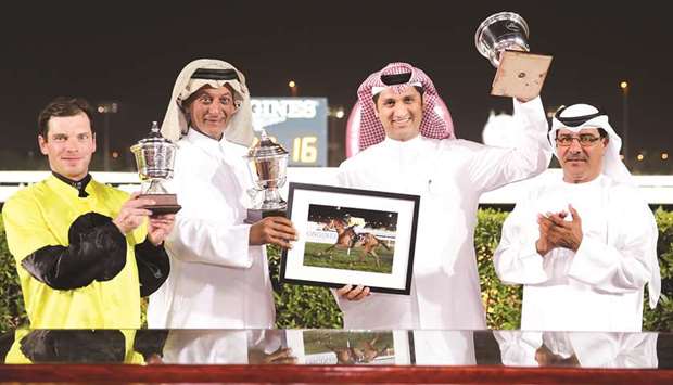 Qatar Racing and Equestrian Club (QREC) Racing manager Abdulla Rashid al-Kubaisi (right) with the winners of the Thoroughbreds Pearl event after Northern Beam won the 2000m race at the Al Rayyan Park yesterday. PICTURES: Juhaim