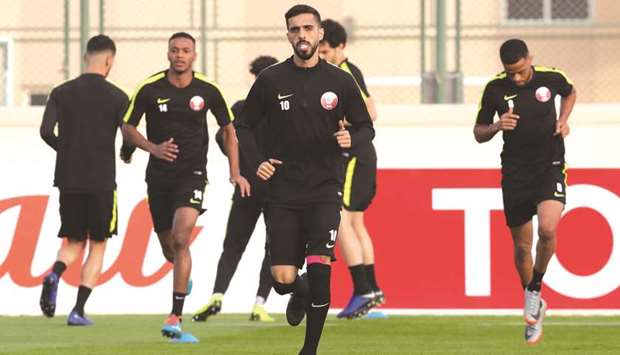 Qataru2019s Hassan al-Haydos and his teammates take part in a training session on the eve of their AFC Asian Cup quarter-final against South Korea yesterday. PICTURES: Fadi al-Assaad