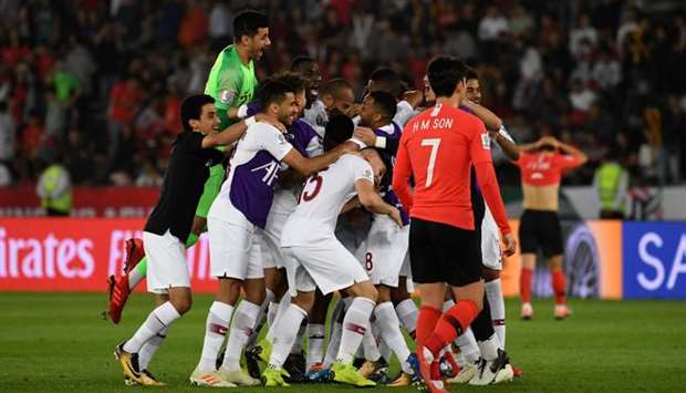 Qatar's players celebrate their win during the 2019 AFC Asian Cup quarter-final football match between South Korea and Qatar at Zayed Sports City in Abu Dhabi