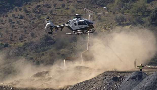 An helicopter of the Spanish Guardia Civil, transporting explosives, lands at the site where a child fell down a well in Totalan, southern Spain