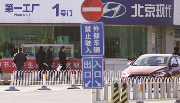 A Hyundai car drives out of a plant of the company on the outskirts of Beijing. The firmu2019s China sales sank 23% in the fourth quarter amid a lack of attractive models and strong branding in the face of competition from both Chinese and global car makers.