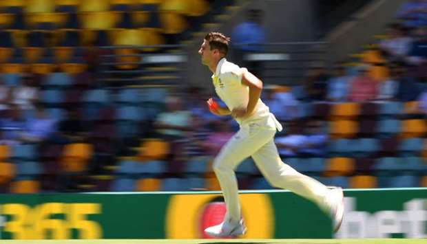 Australia's Pat Cummins bowls during the third day of the day-night Test cricket match between Australia and Sri Lanka at the Gabba in Brisbane