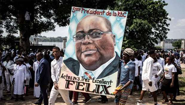 Supporters of new elected President of the Democratic Republic of Congo Felix Tshisekedi hold his portrait and cheer in Kinshasa