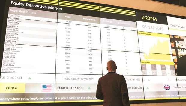 A visitor looks at a digital screen displaying stock futures information at the Johannesburg Stock Exchange (JSE) in the Sandton district of Johannesburg (file). Even after a 7.2% rally since mid-December, the FTSE JSE Africa All Share Index is still near its cheapest relative to emerging-market peers in almost seven years, according to data compiled by Bloomberg.