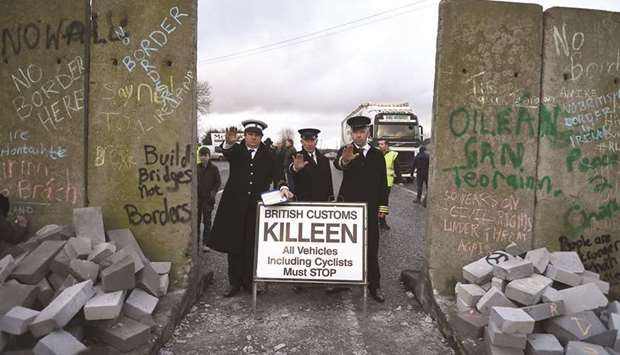 Actors dressed as custom officers stand next to a mock border wall during a protest by anti-Brexit campaigners, Borders Against Brexit, in Carrickcarnan, Ireland.