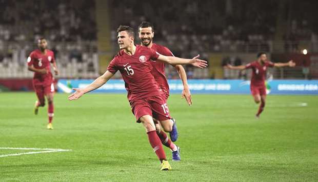Qataru2019s Bassam al-Rawi (foreground) celebrates his goal during the AFC Asian Cup Round of 16 match against Iraq in Abu Dhabi on Tuesday. (AFP)