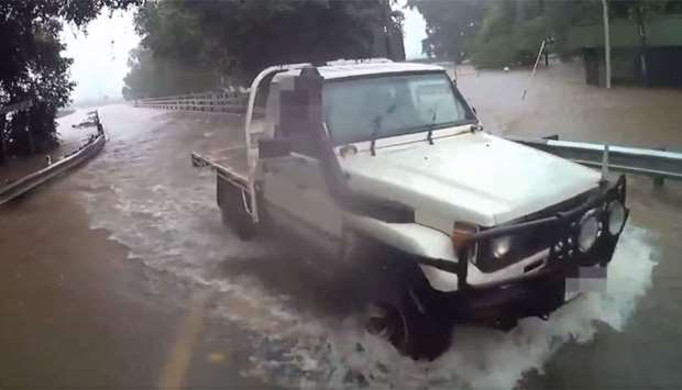 A vehicle on a flooded road in Queensland