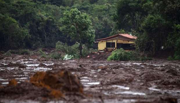 A damaged house is seen at the mud-covered area a day after the collapse of a dam at an iron-ore mine belonging to Brazil's giant mining company Vale near the town of Brumadinho