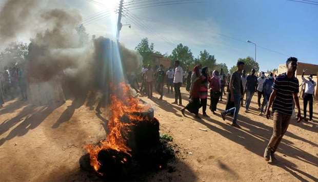Sudanese demonstrators burn tyres as they participate in anti-government protests in Omdurman, Khartoum