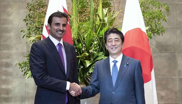 His Highness the Amir Sheikh Tamim bin Hamad Al-Thani shake hands with Shinzo Abe, the Prime Minister of Japan, during the official reception in Tokyo