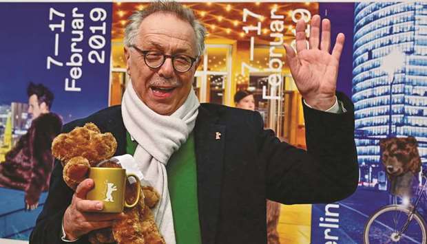 Kosslick poses with Berlinale paraphernalia before giving a press conference in Berlin to present the programme of the 69th Berlin film festival.