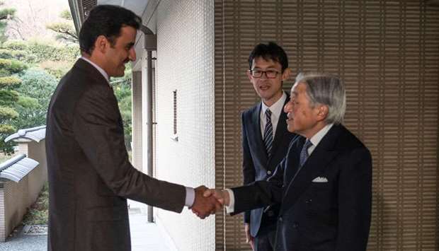 His Highness the Amir Sheikh Tamim bin Hamad Al-Thani shakes hand with Japan's Emperor Akihito.