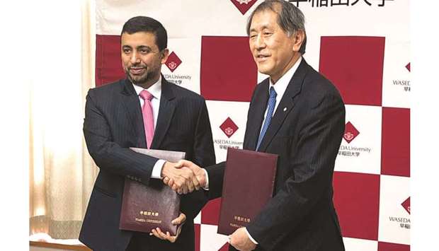 QU president Dr Hassan al-Derham and Waseda University president Dr Aiji Tanaka shake hands after signing the pact.