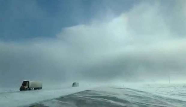 Trucks drive amidst heavy snow near Fargo, North Dakota
