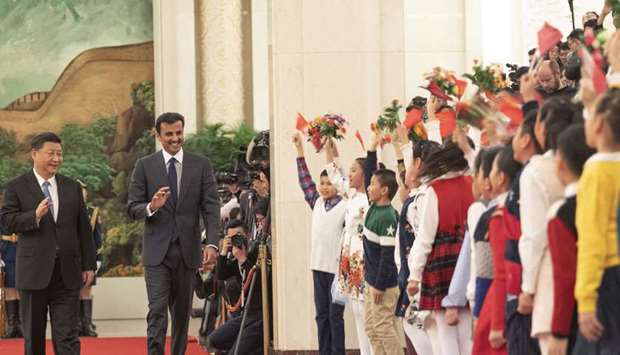Children give a rousing welcome to the Amir and the Chinese President Xi Jinping as they arrive at the Great Hall of the People.