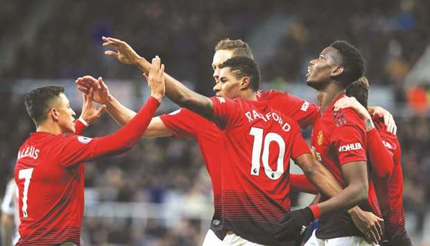 Manchester Unitedu2019s English striker Marcus Rashford (centre) celebrates scoring his teamu2019s second goal with striker Alexis Sanchez (left) and midfielder Paul Pogba (right) during the English Premier League match against Newcastle United in Newcastle. (AFP)