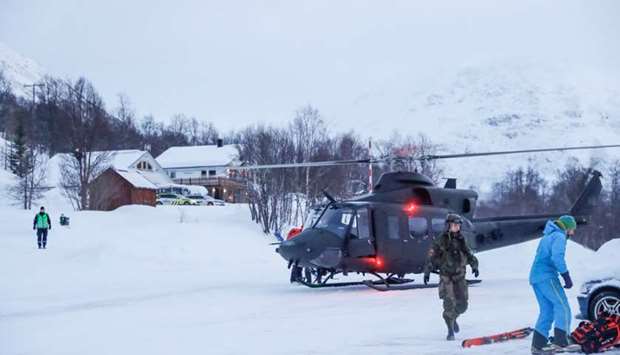 A military helicopter and rescue workers are seen in Tamokdalen, Norway