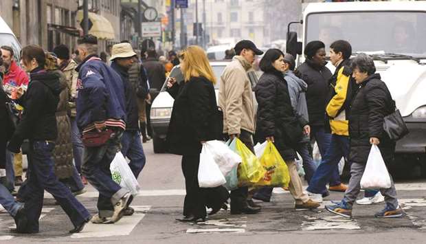 Shoppers walking on the streets in Milan. The Italy PMI suggested its services industry was barely growing after its economy contracted in the third quarter.