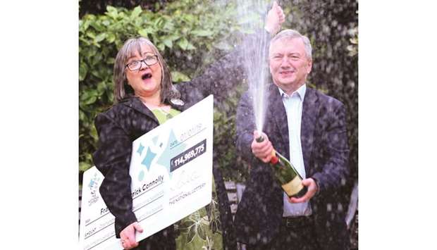 EuroMillions lottery winners, Frances and Patrick Connolly, pose during a photocall at the Culloden Hotel near Belfast yesterday.
