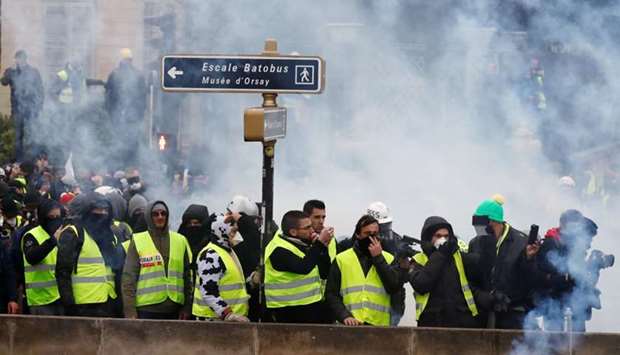Protesters wearing yellow vests take part in a demonstration by the ,yellow vests, movement in Paris, France