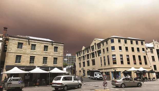 Smoke from a bushfire burning in Wilderness World Heritage area in southwest Tasmania shrouds Salamanca Place in Hobart, Tasmania, yesterday.