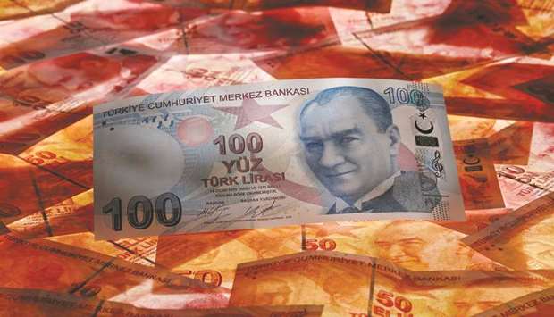 A 100 Turkish lira banknote is seen on top of 50 lira banknotes in this picture illustration in  Istanbul. Leading the charge among currencies on Friday was the lira as it posted its best one-day gain against the greenback since October, and every major emerging-market currencies advanced.
