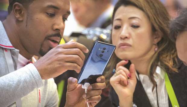 Attendees view the Huawei Technologies Mate 10 Pro smartphone during the 2018 Consumer Electronics Show (CES) in Las Vegas on January 10, 2018. US government officials and industry executives have long harboured suspicions that Huawei works for Chinese government interests. Huawei has pushed back against the accusations, with a top executive citing u201cgroundless speculation.u201d