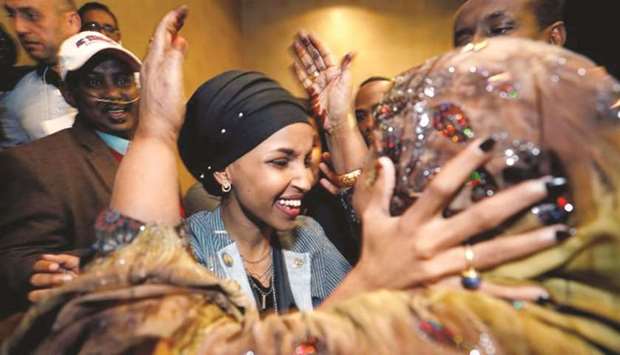 A congressional win by Ilhan Omar, centre, was just one of several historic results from November midterm elections.