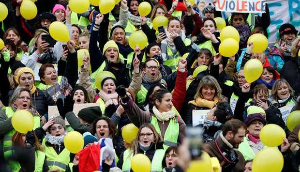 Protesters wearing yellow vests take part in a demonstration by the u201cWomenu2019s yellow vestsu201d movement in Paris, yesterday.