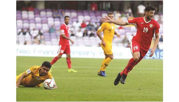 Jordanu2019s Anas Bani-Yaseen (right) in action with Australiau2019s midfielder Massimo Luongo (left) during the AFC Asian Cup match in Al Ain, UAE, yesterday. (AFP)