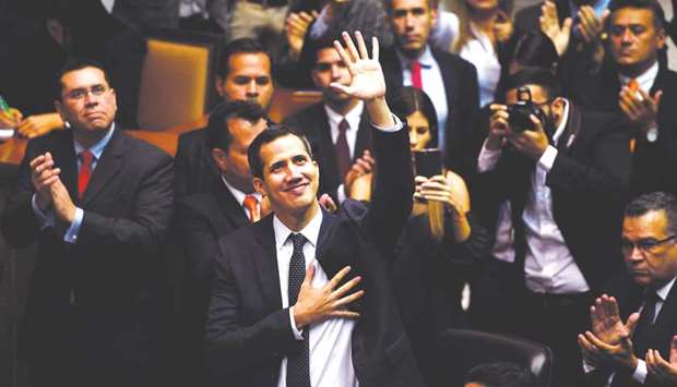 The incoming president of Venezuelau2019s National Assembly, Juan Guaido, centre, waves upon arrival for the inauguration ceremony in Caracas yesterday.