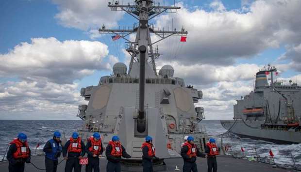 The crew of the Arleigh Burke-class guided-missile destroyer USS McCampbell (DDG 85) handle the phone and distance line during a replenishment-at-sea with the USNS Pecos (T-AO-197) in the East China Sea, December 27, 2018