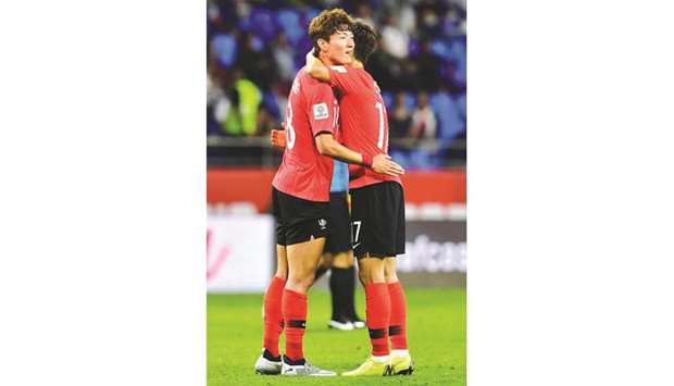 South Korea forward Hwang Uijo (L) midfielder Lee Chung-yong celebrate after winning their teamu2019s match against the Philippines in Dubai yesterday.