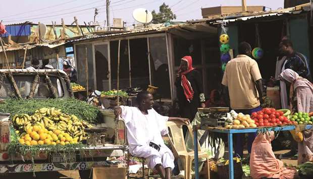 Traders display their groceries along a street as they wait for customers in Khartoum, yesterday.
