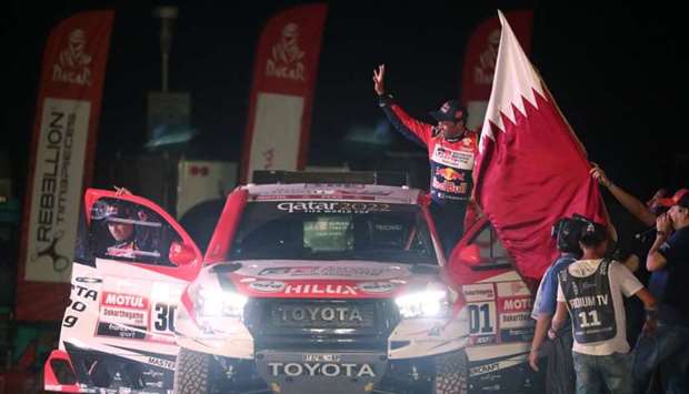 Qatar's Nasser Al-Attiyah and French co-pilot Mathieu Baumel of the Toyota Gazoo Racing SA Team wave at fans in Lima, Peru on January 6, 2019. Reuters