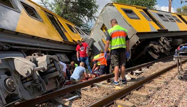 Emergency services are seen at the site of a train crash in Pretoria, South Africa. TWITTER/@ABRAMJEE/via REUTERS