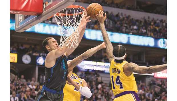 Dallas Mavericks forward Dwight Powell (left) and Los Angeles Lakers forward Brandon Ingram (right) fight for the rebound during the second quarter of their NBA game at the American Airlines Center. PICTURE: USA TODAY Sports