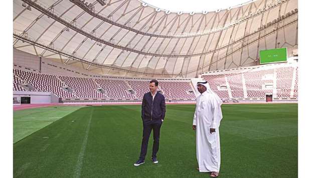 Abdullah al-Khater (right), Director of Events and Venues at AZF, gives Oliver Bierhoff, General Manager of Germanyu2019s national team, a tour of Khalifa International Stadium.