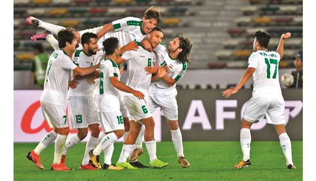 Iraqu2019s Ali Adnan (third from right) celebrates with teammates after scoring a goal during the 2019 AFC Asian Cup group D match against Vietnam in Abu Dhabi yesterday. (AFP)