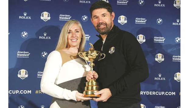 Padraig Harrington poses with the Ryder Cup and his wife Caroline after being appointed as the European Ryder Cup Captain for The 2020 Ryder Cup, (Reuters)
