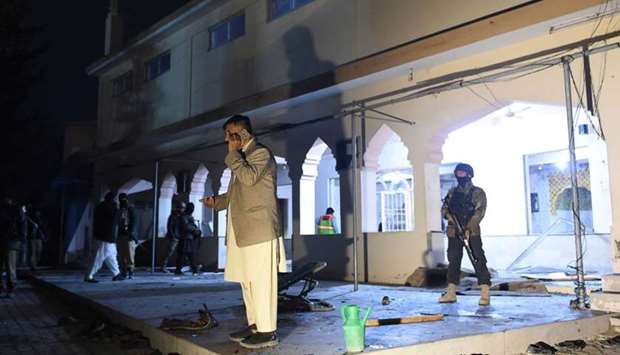Security officials gather at a mosque after a bomb blast in Quetta. AFP