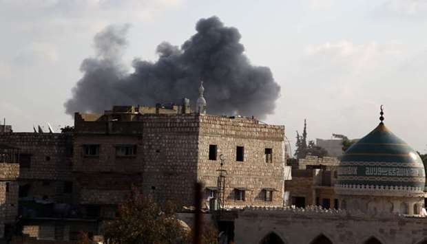 Smoke billows above buildings in the town of Maaret Al-Numan in Syria's northwestern Idlib province during a reported air strike by pro-regime forces today