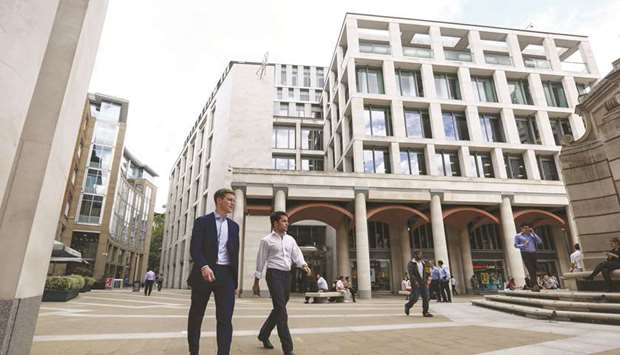 Pedestrians pass the London Stock Exchange Group offices in Paternoster Square. The FTSE 100 closed 0.1% down at 7,587.85 points yesterday.