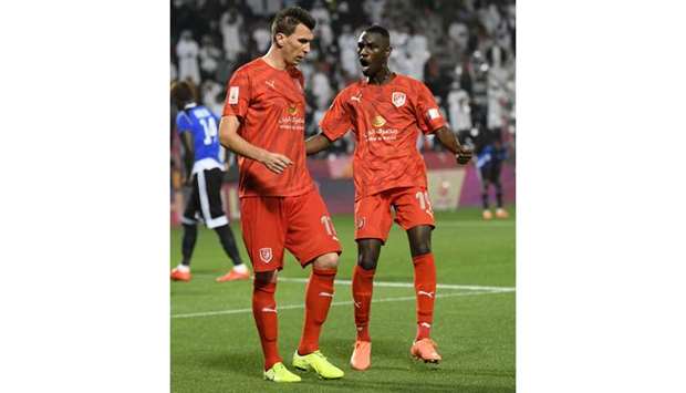 Al Duhailu2019s Almoez Ali (right) celebrates with teammate Mario Mandzukic after the latter scored a goal during the Qatar Cup 2020 semi-final against Al Sailiya at the Al Sadd Stadium yesterday. (Below) Al Duhail head coach Rui Faria. PICTURES: Shemeer Rasheed