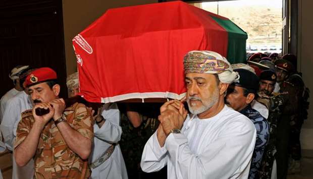 Oman's newly sworn-in Sultan Haitham bin Tariq al-Said carries the coffin of the late Sultan Qaboos, during the funeral in Muscat. Reuters