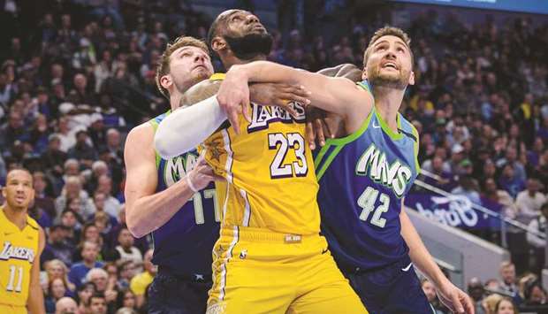 Dallas Mavericks forward Luka Doncic (77) and forward Maxi Kleber (42) defend against Los Angeles Lakers forward LeBron James (23) during the second half at the American Airlines Center. PICTURE: Jerome Miron-USA TODAY Sports
