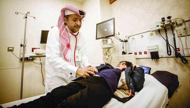 Dr Khalid Mohammed Abdulla al-Ansari treats a child.