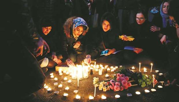 Iranians light candles for the victims of Ukraine International Airlines Boeing 737 during a gathering in front of the Amirkabir University in the capital Tehran, yesterday.