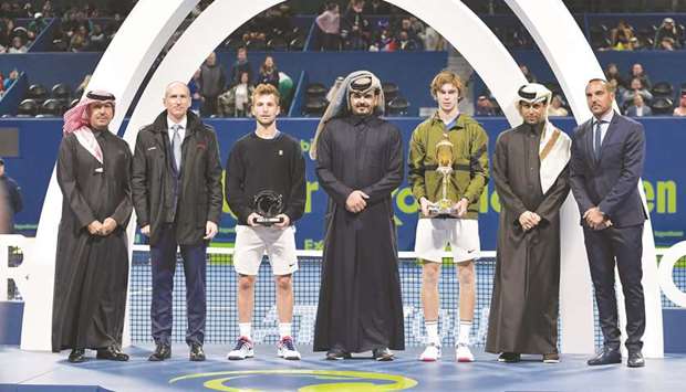 Russiau2019s Andrey Rublev (third from right) poses with the Qatar ExxonMobil Open winneru2019s trophy along with Qatar Olympic Committee (QOC) President HE Sheikh Joaan bin Hamad al-Thani (centre), Qatar Tennis Federation president Nasser bin Ghanim al-Khelaifi (second from right), ExxonMobil Qatar president and general manager Alistair Routledge (second from left), tournament director Karim Alami (right) and runner-up Corentin Moutet of France (third from left) and Saleh al-Mana (left), vice-president and director of Government and Public Affairs, ExxonMobil Qatar, at Khalifa International Tennis and Squash Complex yesterday. PICTURE: Jayan Orma 